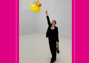 Elena pointing at a yellow plastic duck in the sky