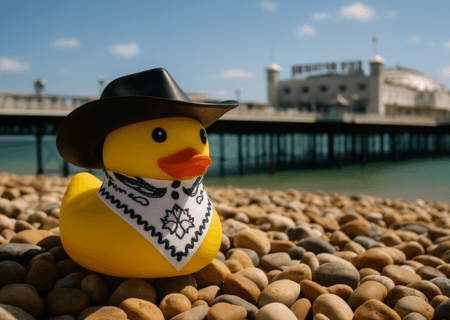Plastic yellow cowboy duck in front of Brighton Pier